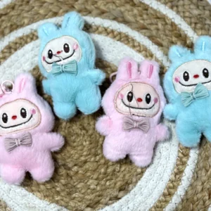Fluffy labubu keychain set of 2 with embroidered faces and bow ties in pastel colours.