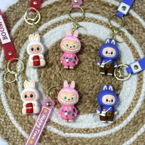 cute bunny character labubu keychains with colorful boom straps, secure metal clasp and pastel colors on woven mat.
